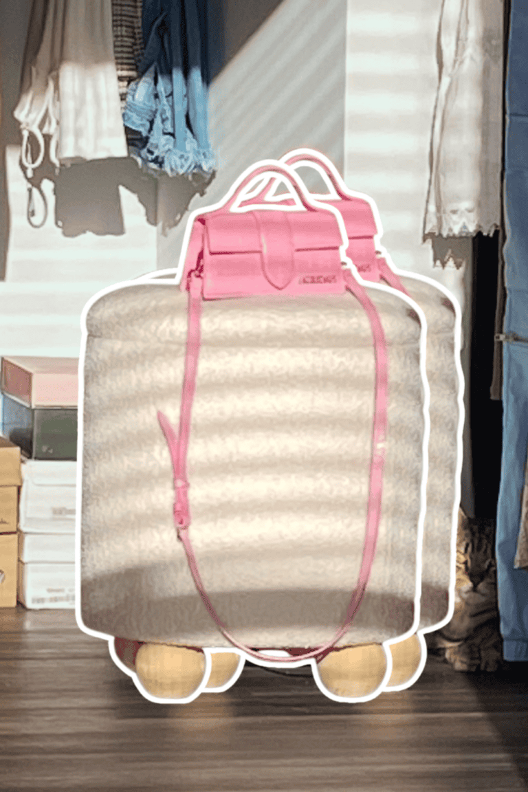 Travel luggage with pink accents in a cozy closet setting.