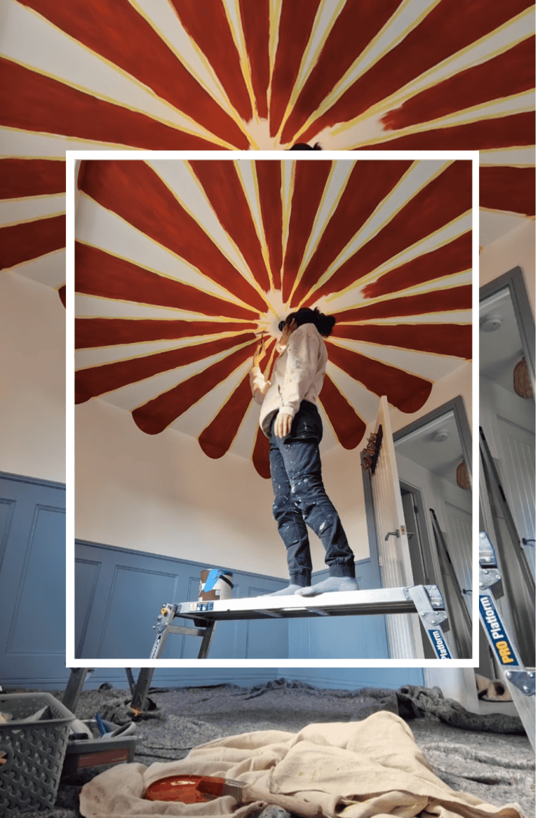 Ceiling artist installing a sunburst pattern on the ceiling with warm tones.